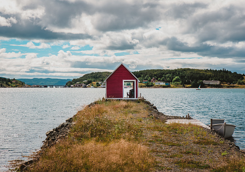 Red fishing shed in rural Newfoundland community on the ocean. in Little Bay Islands, Newfoundland and Labrador, Canada