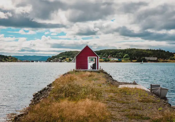 Photo of Red fishing shed in rural Newfoundland community on the ocean.