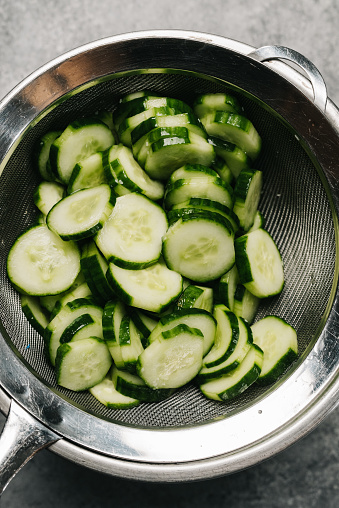 Straining excess liquid from cucumbers in Frederick, Maryland, United States