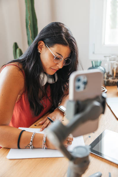 istock Influencer reviewing her live broadcast schedule 1425937909