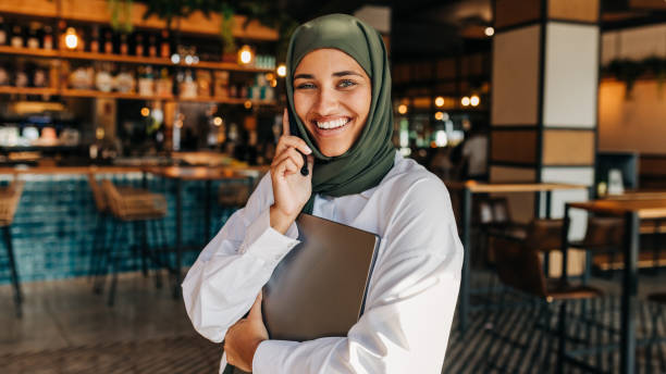 istock Happy Muslim freelancer making a phone call in a cafe 1425938073