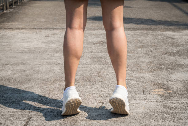 Cropped shot of female runner standing on her tiptoes for strengthen her calves. Toe stretches can help keep you healthy and prevent common runner injuries. tiptoe stock pictures, royalty-free photos & images