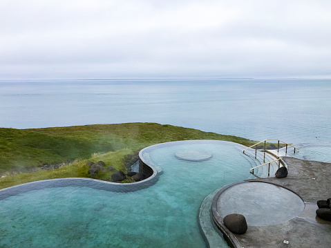 Empty Geosea Geothermal Sea Baths, Husavikurhofdi, Husavik, North Iceland, June 30, 2022 : It is thermal bath just outside of Husavik town in Northern Iceland.  It has a spa and a great infinity pool view over the ocean.  It is very popular with tourists to this area.