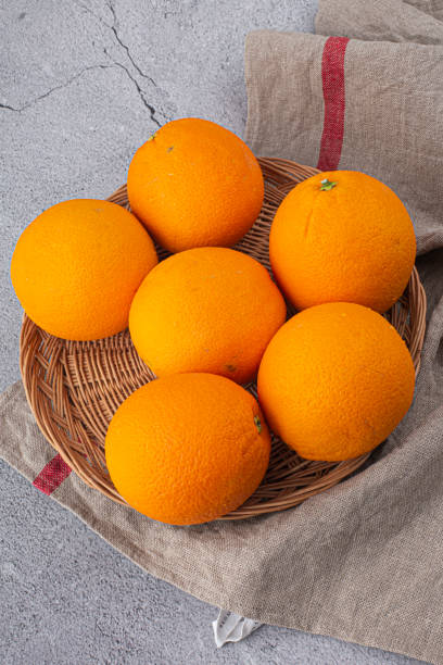 istock Whole fresh orange with grey background. 1425940589