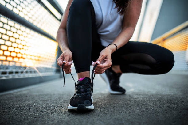 istock Unrecognizable Woman Exercise Outdoors tying shoelaces 1425941593