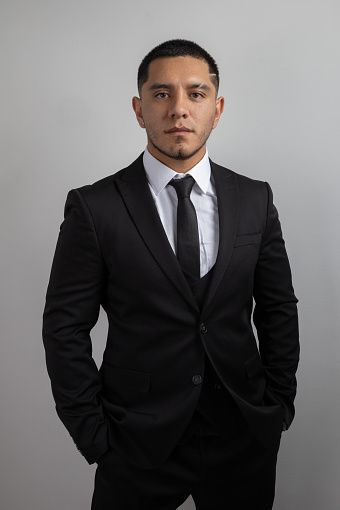 details of a young latin man with short hair, business person and businessman lifestyle, fashion with elegance of a suit with shirt and tie, studio