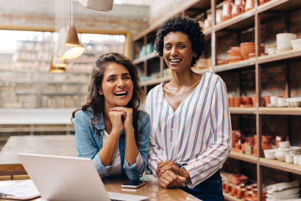 istock Successful shop owners smiling at the camera in their ceramic store 1425946036