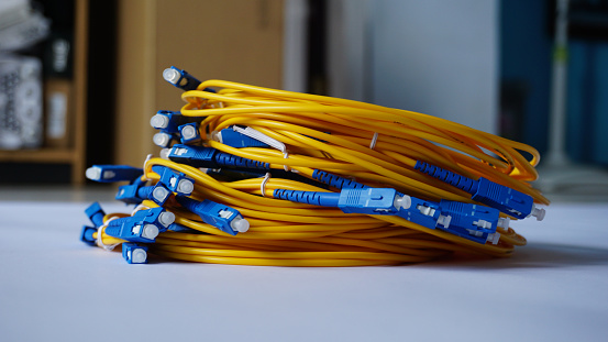 photo of pile of fiber optic cables with adapters installed