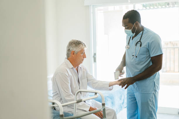 istock Nurse taking temperature to senior patient at home 1425950826