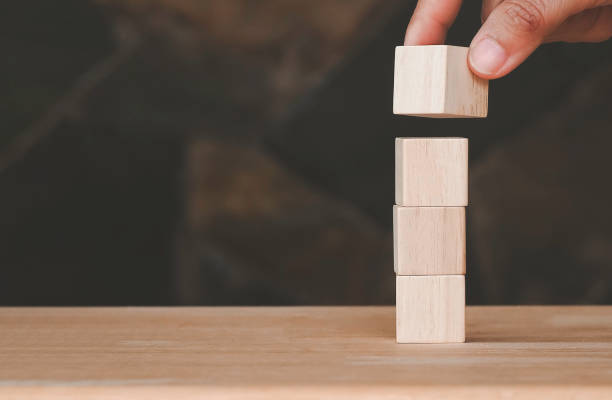 istock Hand arranging wood block stacking as step stair. Business concept for growth success process. Business development strategy and action plan concept 1425951626