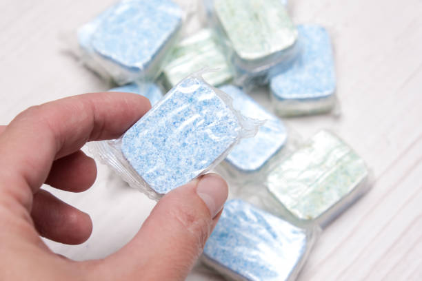 istock A hand holding and showing a dishwasher, dishwashing machine tablet 1425954883