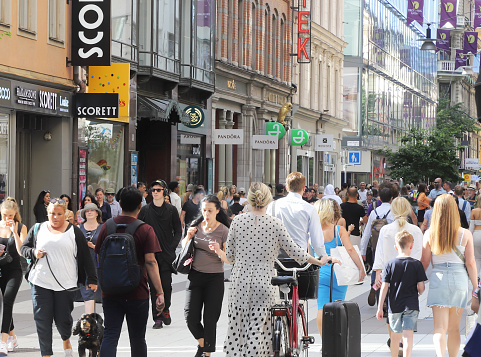 Stockholm, Sweden - July 12, 2022: People at the pedestrian only Drottningatan street in the Stockholm downtown area.