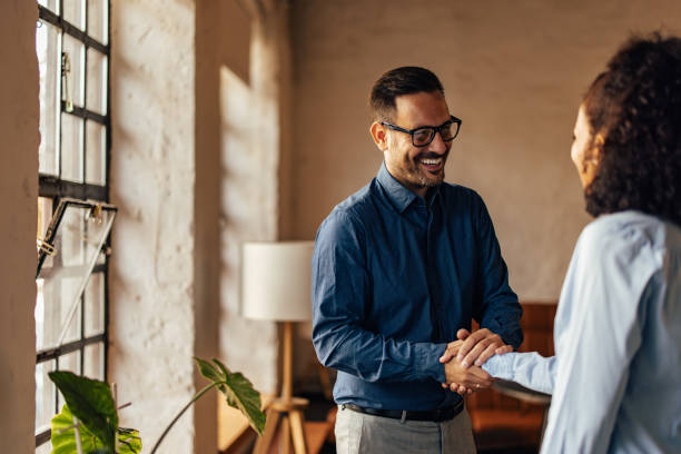 istock Business people shaking hands with each other, at the office. 1425957845