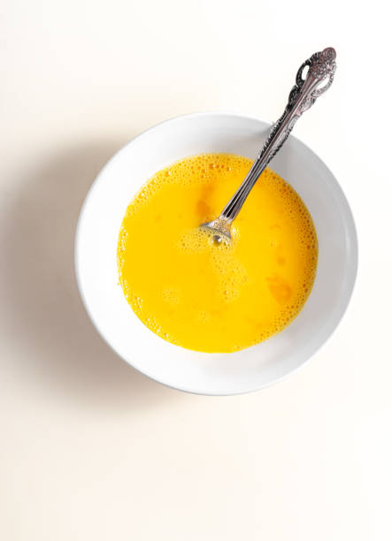 istock A beaten egg in bowl. Top view. White background. Close up. 1425958723