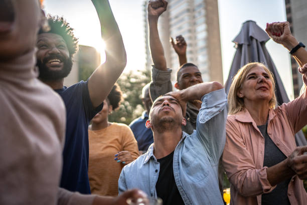 istock Sports fans watching a match at a bar rooftop 1425959355