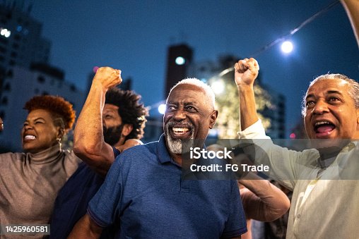 istock Sports fans watching a match at a bar rooftop 1425960581