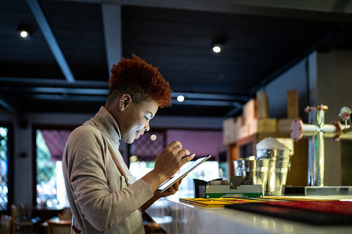 Waitress using digital tablet in a restaurant