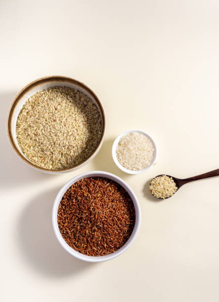 istock Uncooked rice assortment in bowl on white background. Top view. 1425962199