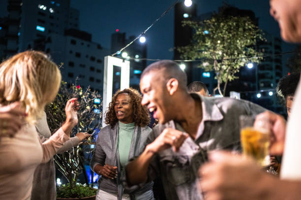 istock Happy friends dancing during party at night 1425963140