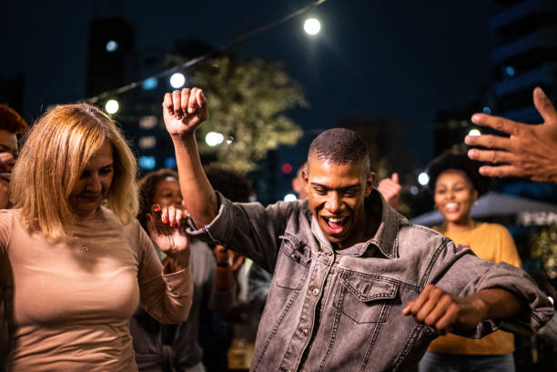 istock Happy friends dancing during party at night 1425963216