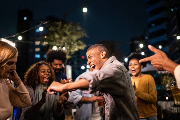 istock Happy friends dancing during party at night 1425963236