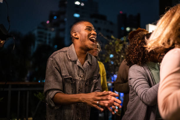 istock Happy friends dancing during party at night 1425963243