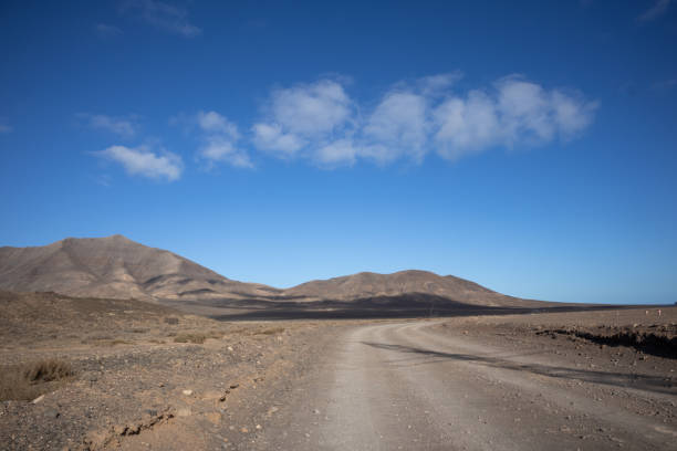 istock Dusty road and mountains, Lanzarote, Spain 1425968764