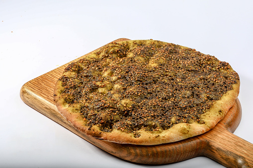 THYME PASTRY pizza served in a cutting board isolated on grey background top view of arabian fastfood