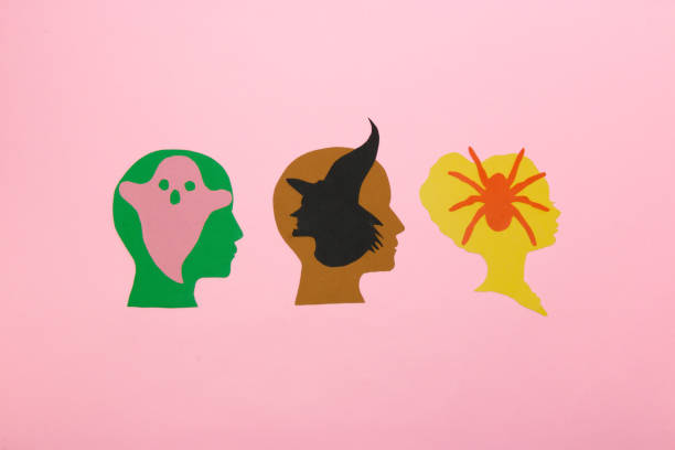 istock 3 paper heads, the first with a ghost, the second with a witch, the third with a spider, creative halloween concept, flat lay, paper craft 1425971459