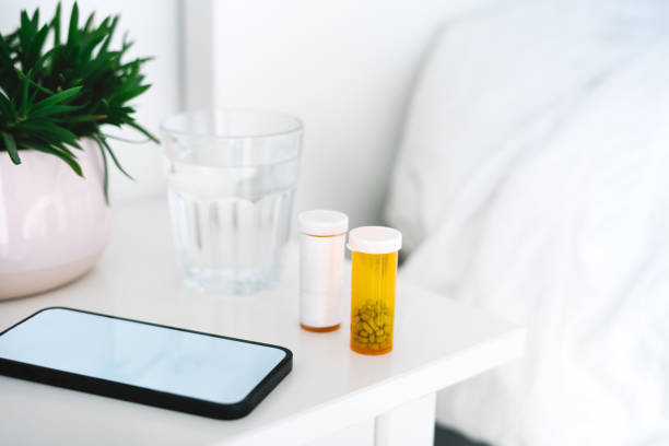 istock Pill bottles next to a smartphone on the nightstand 1425971514