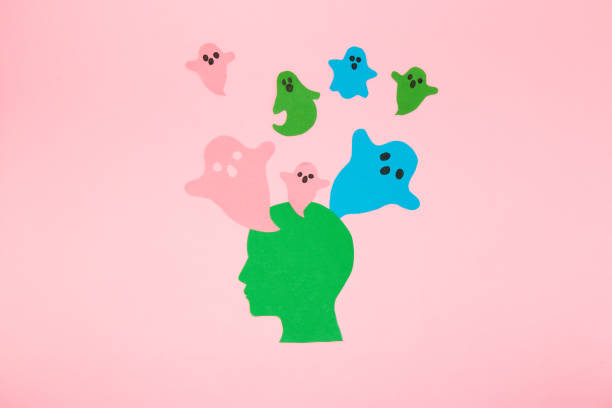istock green paper head from which colorful spirits fly, possessed head, halloween creative concept, flat lay, paper craft 1425971604