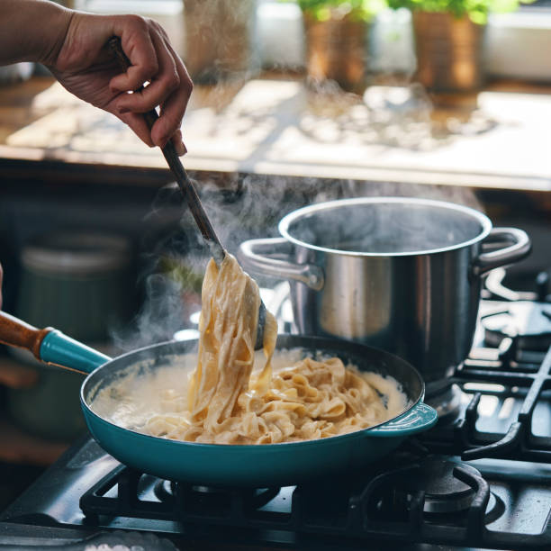 istock Preparing Fettuccine Pasta Alfredo with Parmesan 1425972078