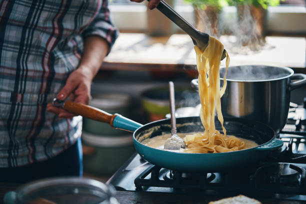 istock Preparing Fettuccine Pasta Alfredo with Parmesan 1425972080
