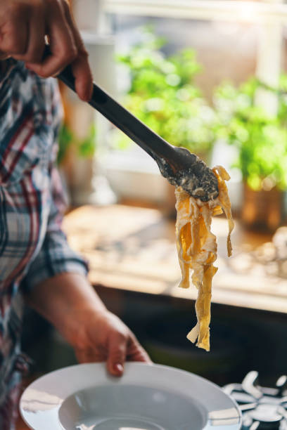 istock Preparing Fettuccine Pasta Alfredo with Parmesan 1425972116