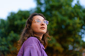 Portrait of woman in eyeglasses looking at something with awe