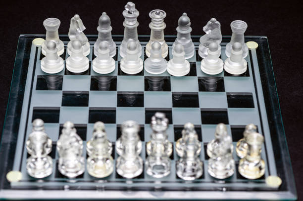 istock Set of glass chess pieces over black, selective focus, copy space 1425979459