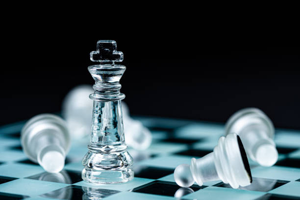 istock glass chess board game in black background ,selective focus on King, leadership concept 1425979537