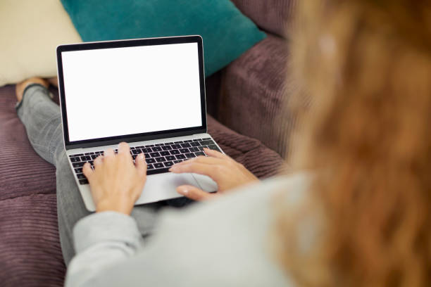 istock Woman surfing internet on laptop with blank screen 1425983079
