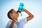 istock Cute Boy Drinking Water 1425983226