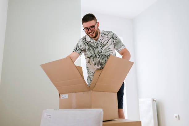 istock A young man is packing and unpacking as he is moving into a new house. 1425985848