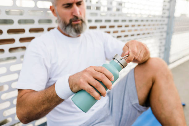 istock Senior man drinking water after intensive workout 1425986304