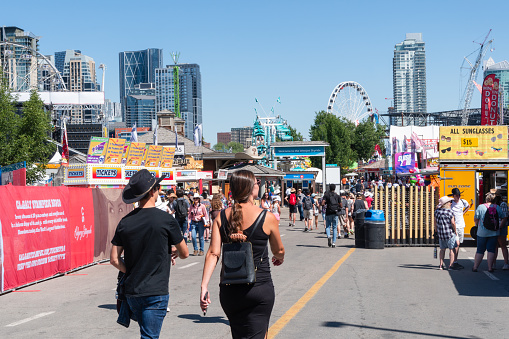 Calgary, Alberta, Canada - July 15, 2022: People enjoy the Calgary Stampede at the Stampede Park in summer