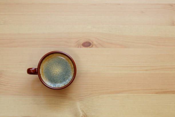 istock A cup of coffee is on a wooden table. Space for text. 1425989510