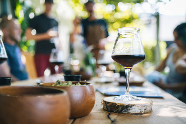 Place settings and beer in wineglass Wooden table agritourism stock pictures, royalty-free photos & images