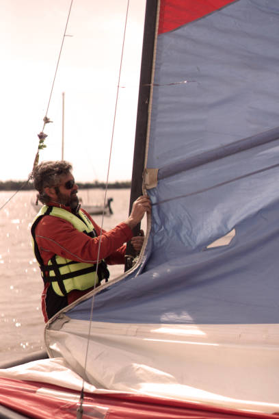 istock man on the beach to go sailing 1425991537