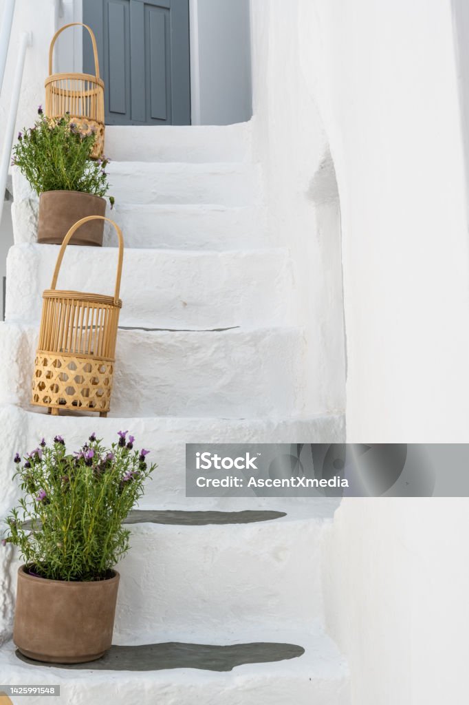 White steps and potted plants Colourful details Greece Stock Photo