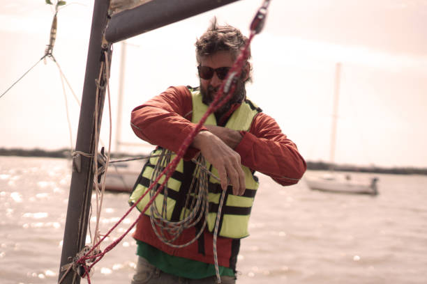 istock man on the beach to go sailing 1425991591
