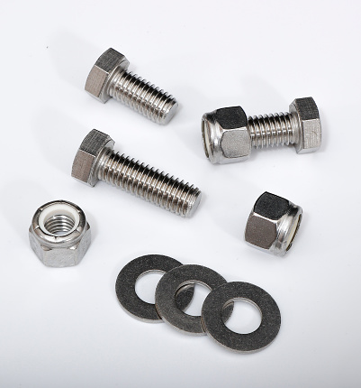 Male screw and hexagon nut, flat nut washer and spring washer coated with a protective layer of zinc isolated on white background
