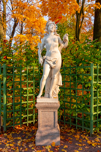Saint Petersburg, Russia - September 2021: Sculpture of Summer garden in autumn foliage