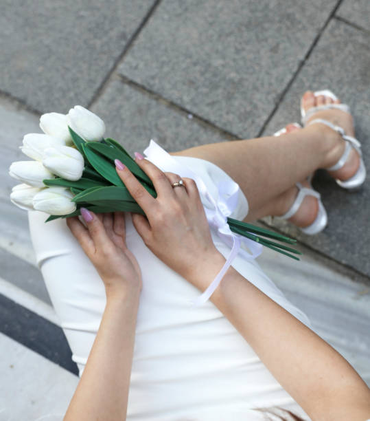 istock Bride hands with ring and wedding bouquet of flowers 1425994099